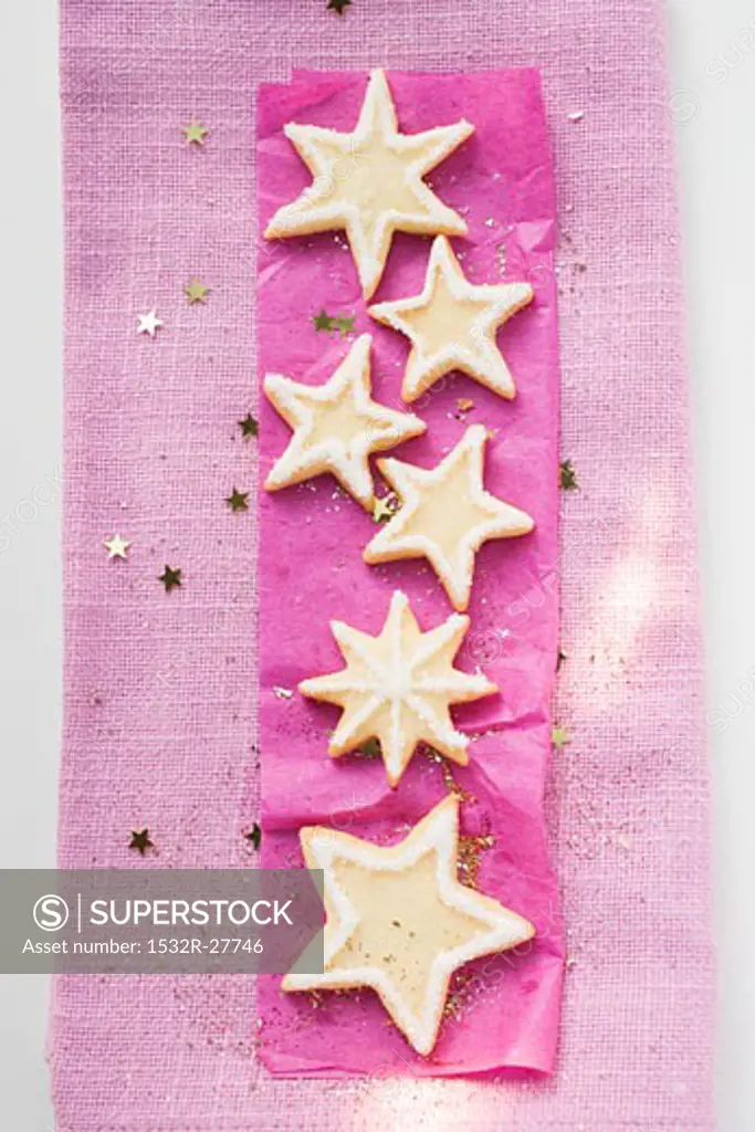 Star biscuits with sugar on purple paper (for Christmas)