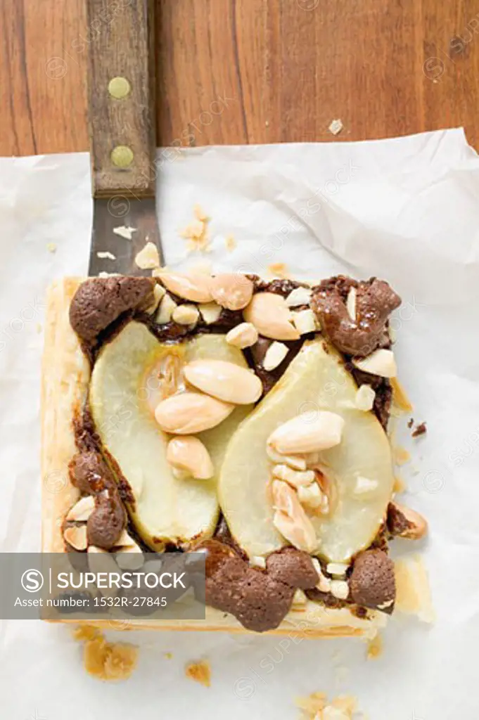 Piece of pear and chocolate tart with almonds