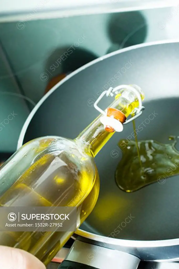 Pouring olive oil into frying pan