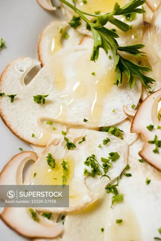 Cep carpaccio with olive oil and herbs (close-up)