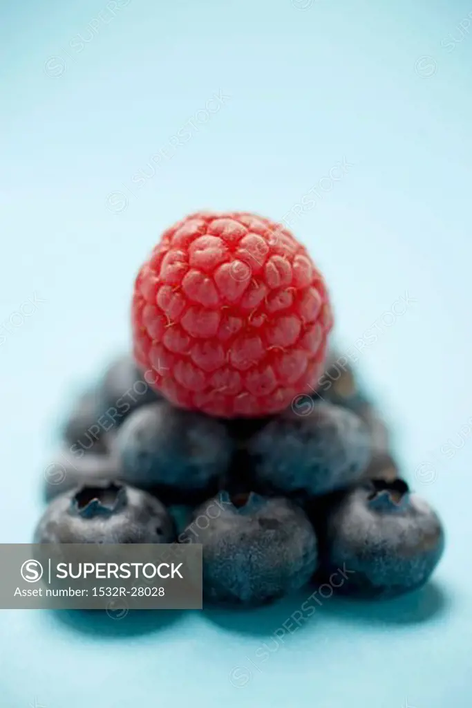 Blueberries and raspberry on blue underground