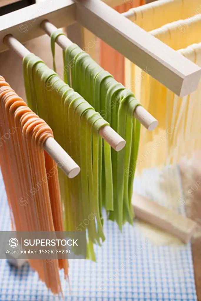 Home-made ribbon pasta, hanging up to dry