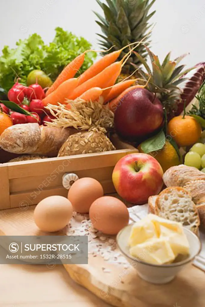 Still life: vegetables, fruit, eggs, butter & wholemeal bread