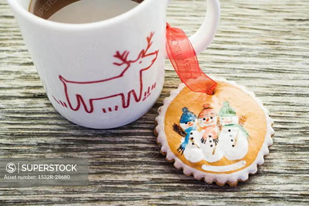 Gingerbread tree ornament and cup of cocoa