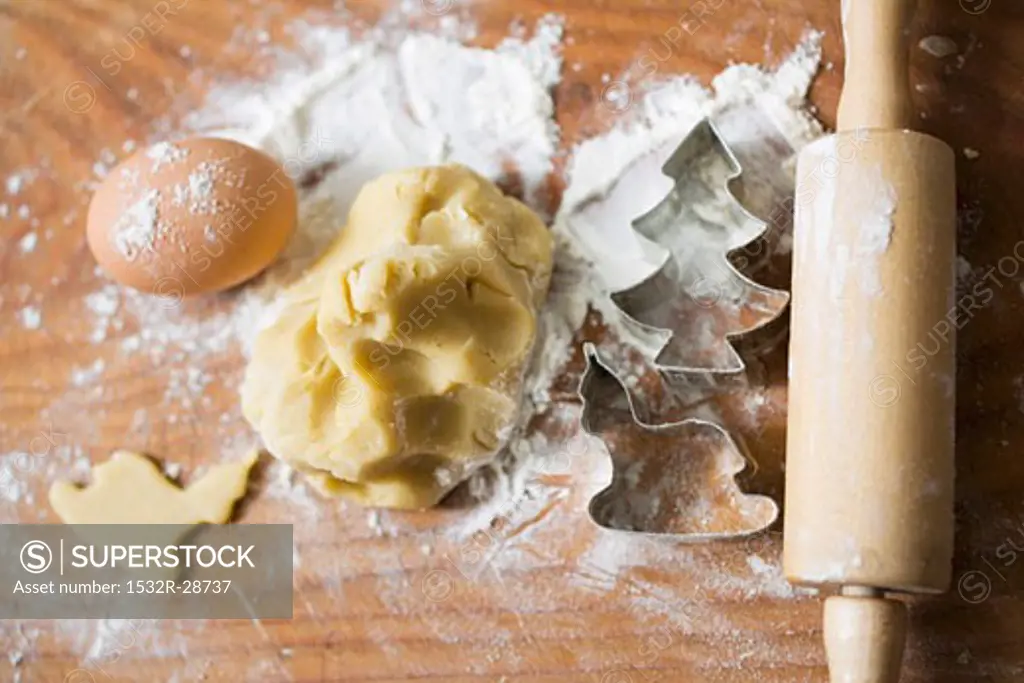 Biscuit dough, biscuit cutters, flour, egg and rolling pin