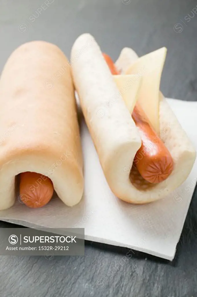 Two hot dogs with cheese