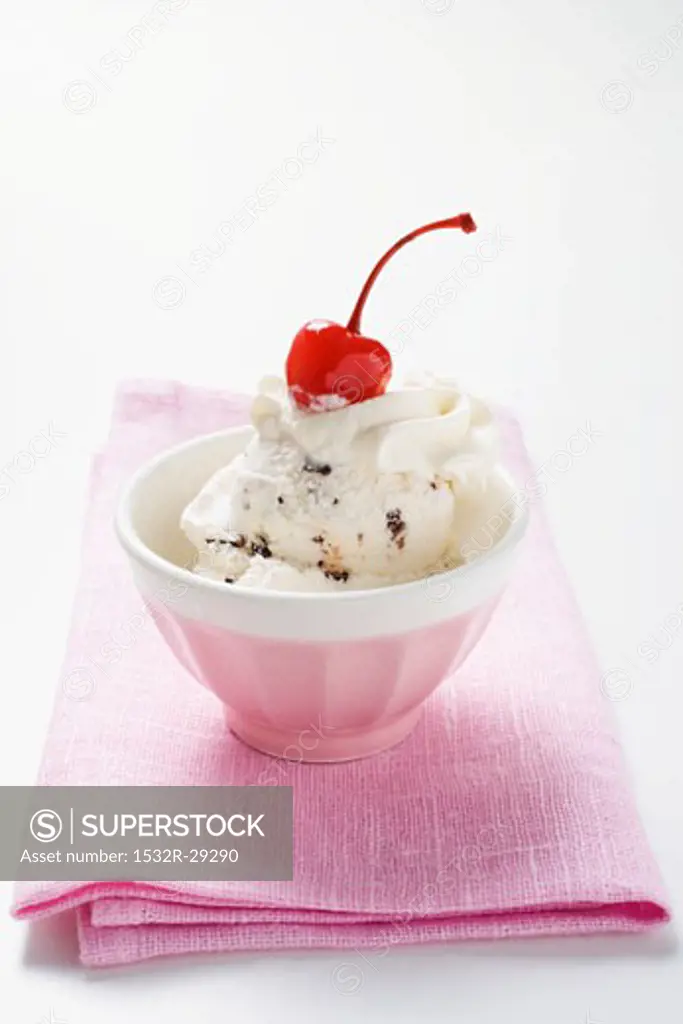 Stracciatella ice cream with cream and cherry