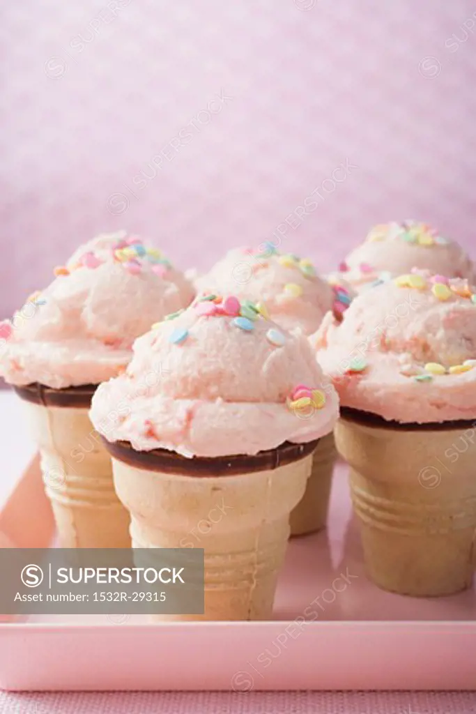Strawberry ice cream cones on pink tray