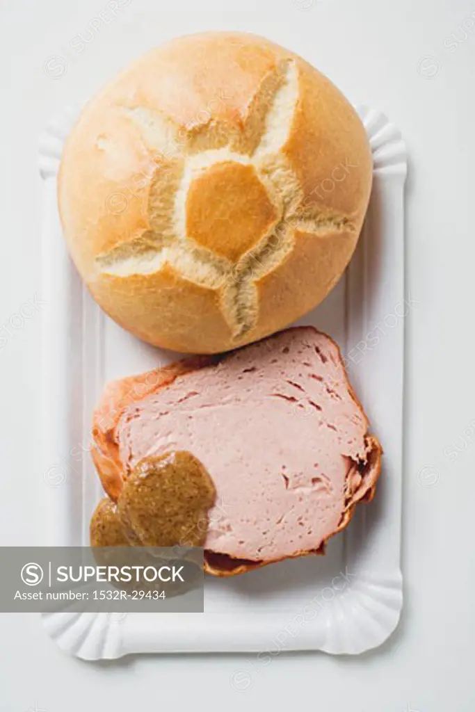 Leberkäse with bread roll and mustard on paper plate