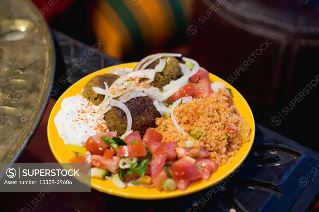 Falafel with couscous, tomato salad & yoghurt (N. Africa)