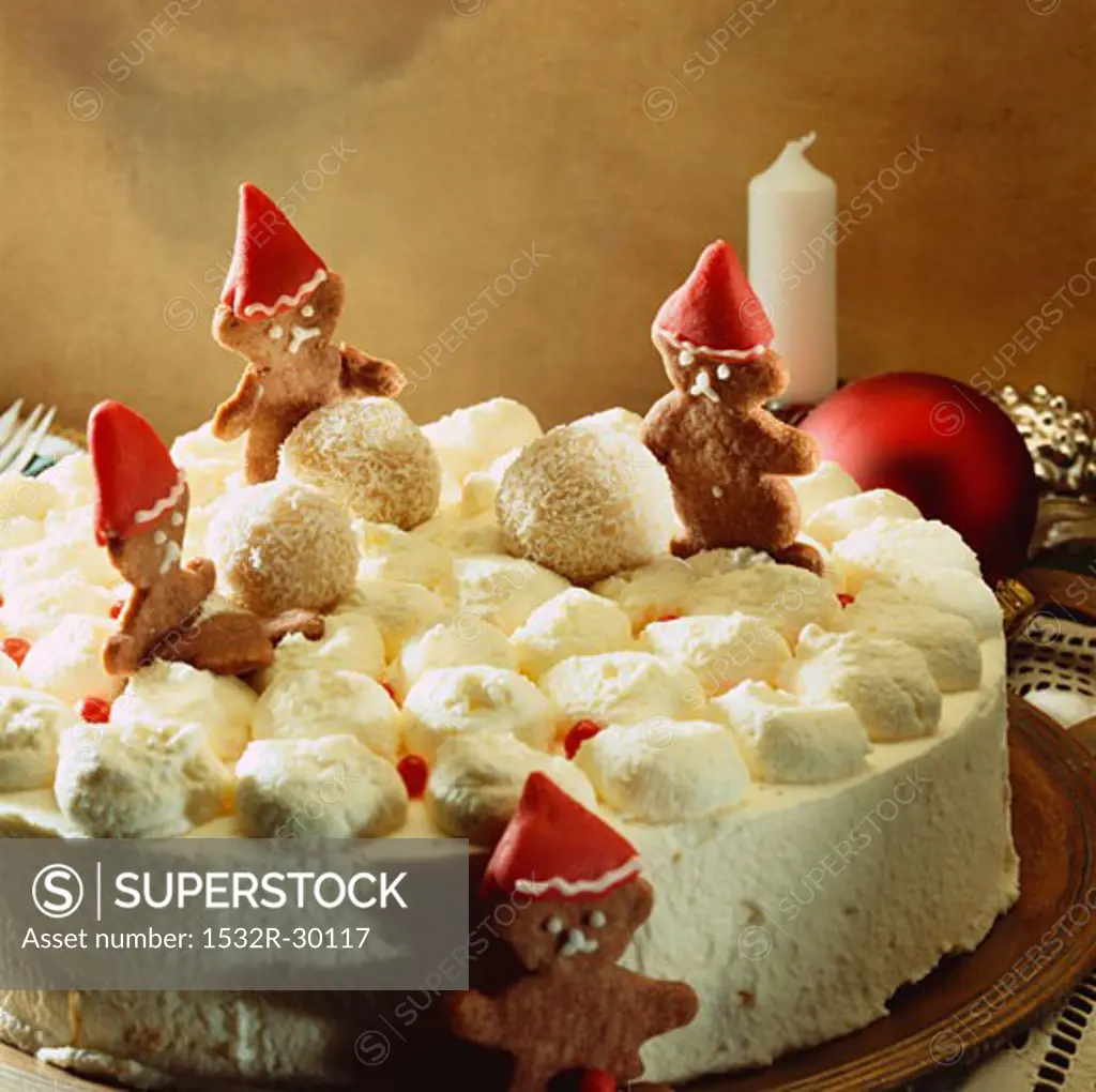 Cream cake for Christmas decorated with gingerbread figures