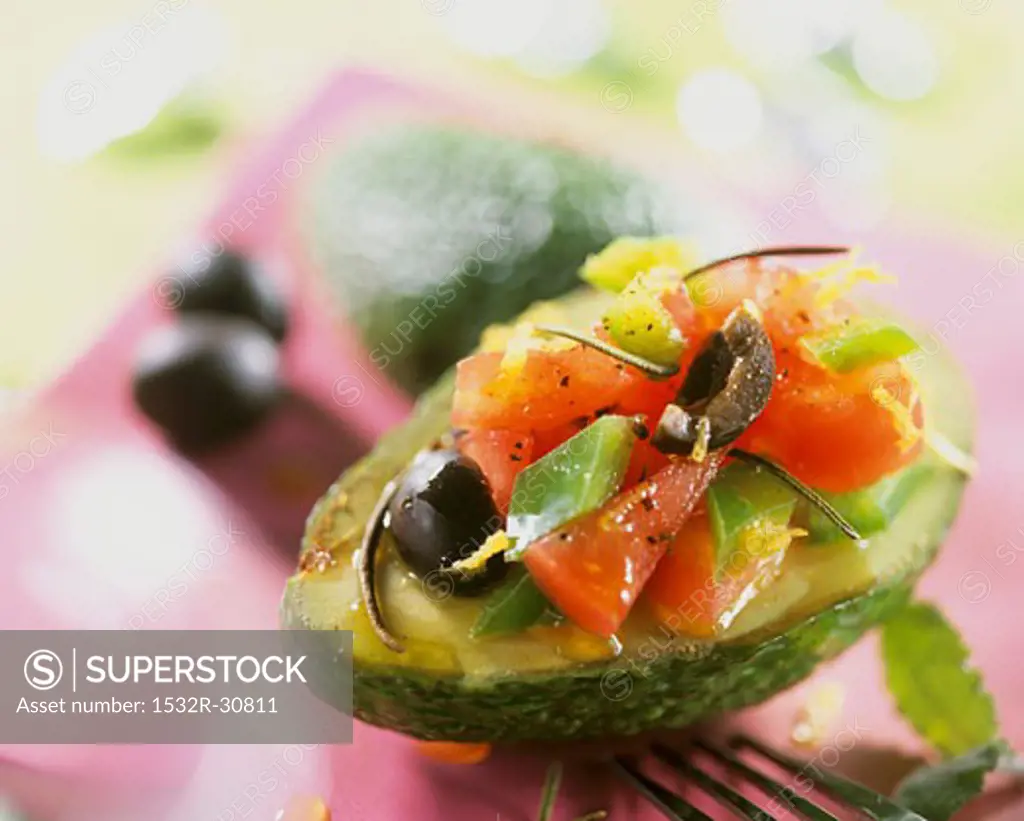 Avocado stuffed with tomato, pepper and olive salad