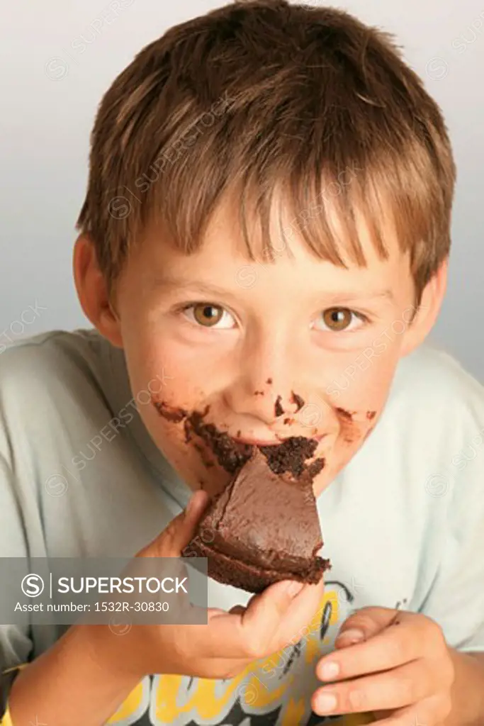 Boy eating a piece of chocolate cake