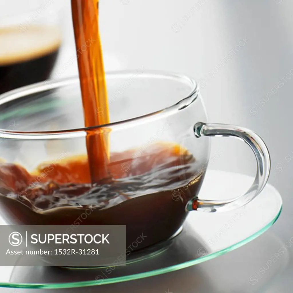 Pouring coffee into a glass cup