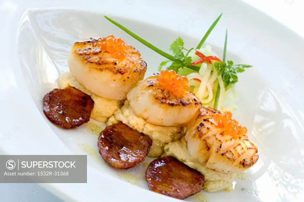 Fried scallops with caviar, mashed potato and sausage