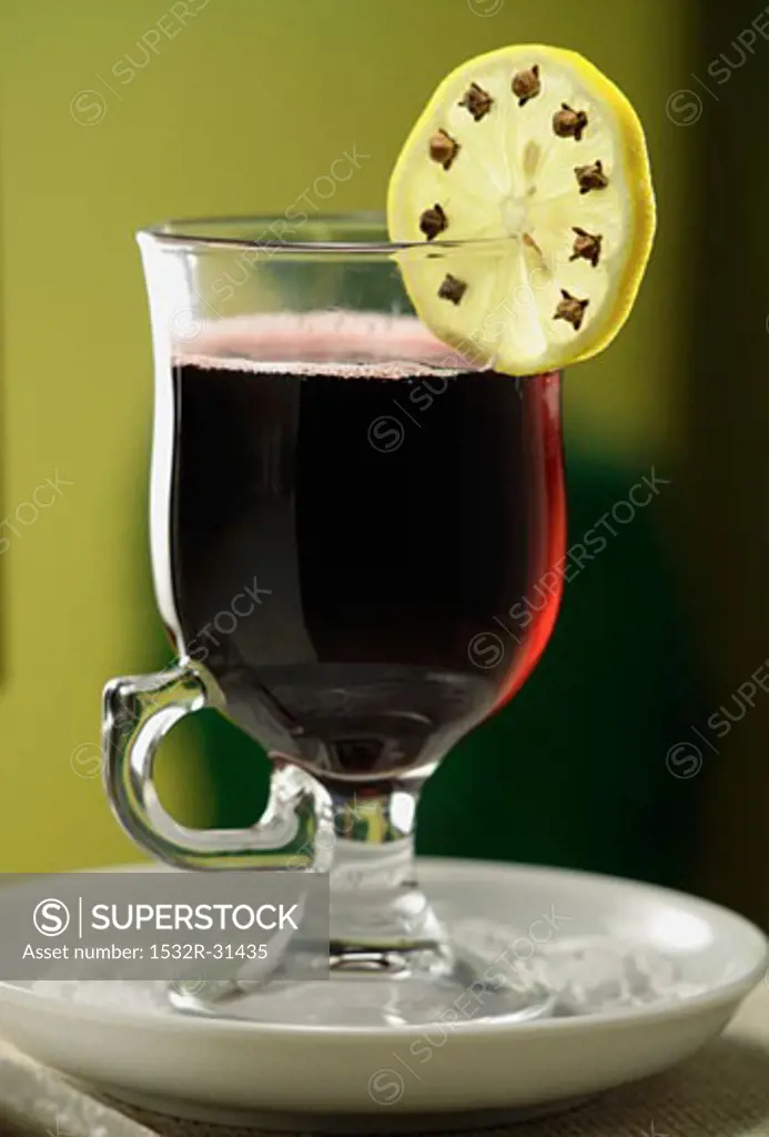 Mulled wine with clove-studded slice of lemon