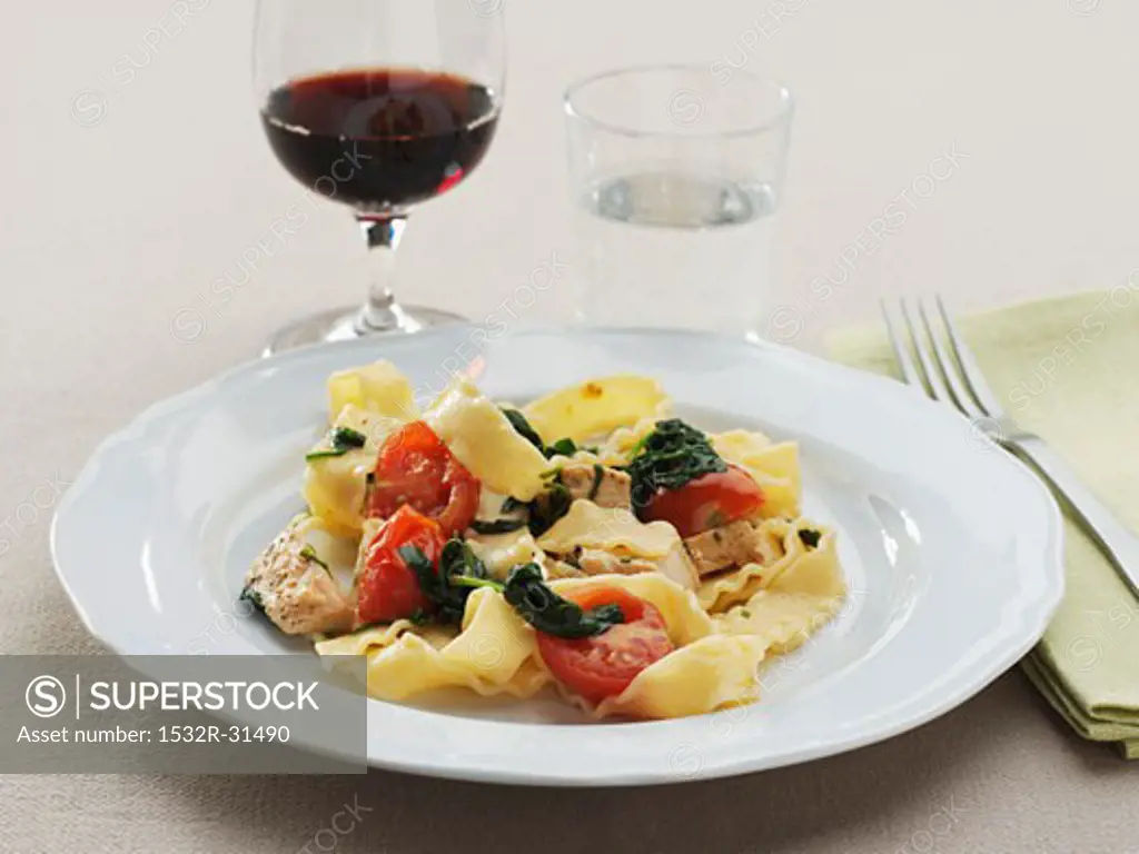 Ribbon pasta with pork, spinach and cocktail tomatoes