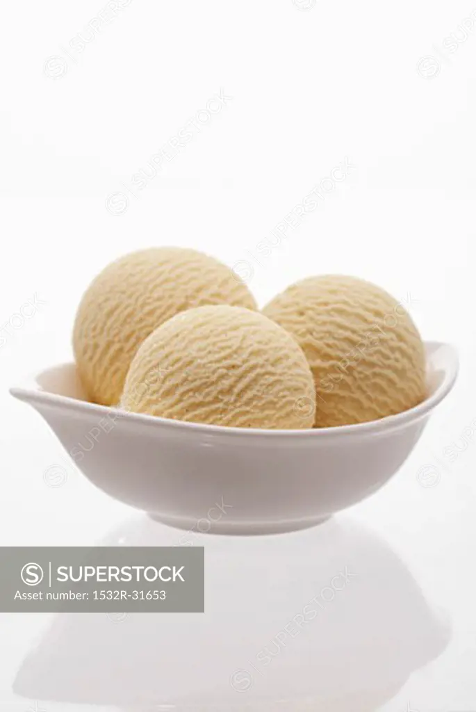 Three scoops of vanilla ice cream in a dish