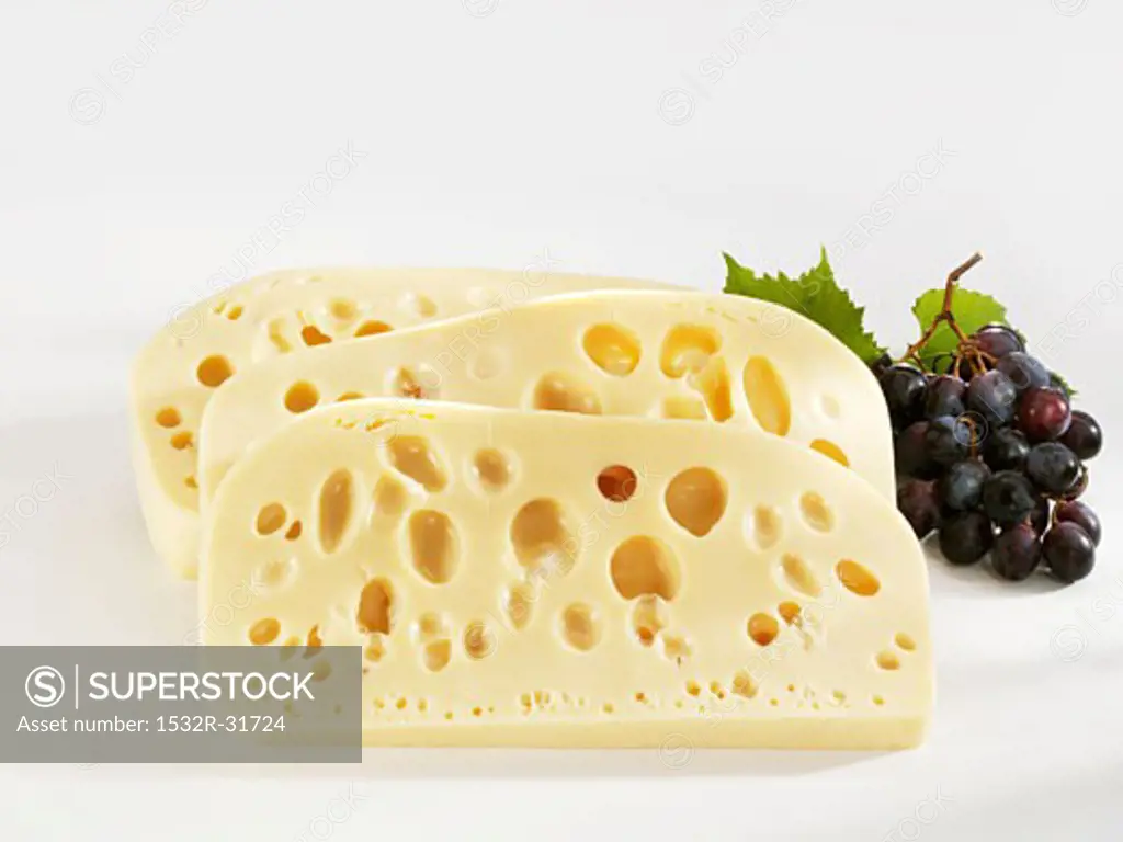 Three slices of Leerdammer cheese with grapes