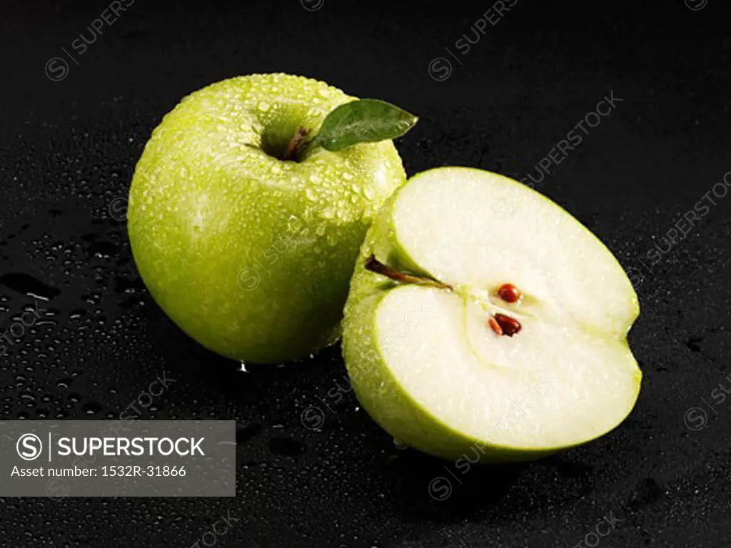Whole and half 'Granny Smith' apple