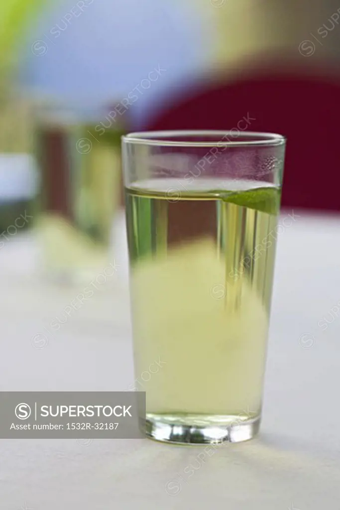 A glass of green tea with mint