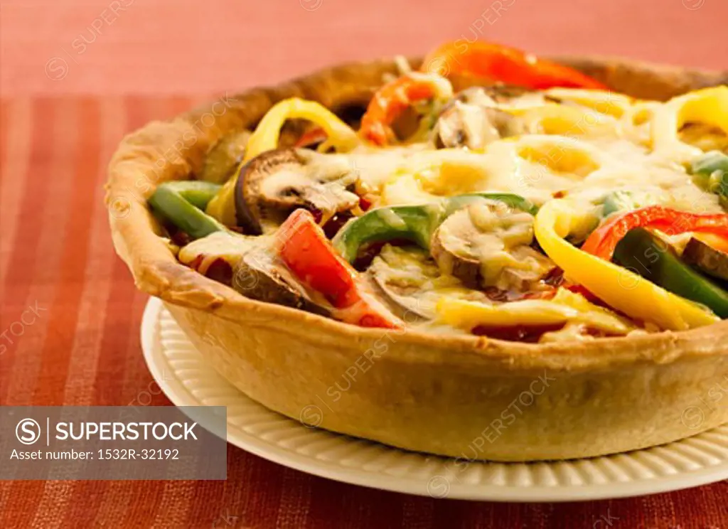 Pepper and mushroom tart with melted cheese topping