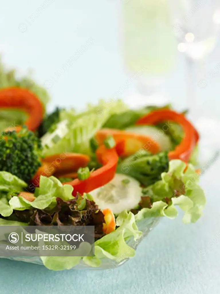 Mixed salad with lettuce and peppers on a glass platter