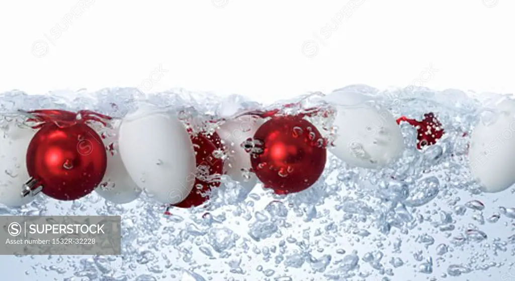 Eggs and Christmas baubles in bubbling water