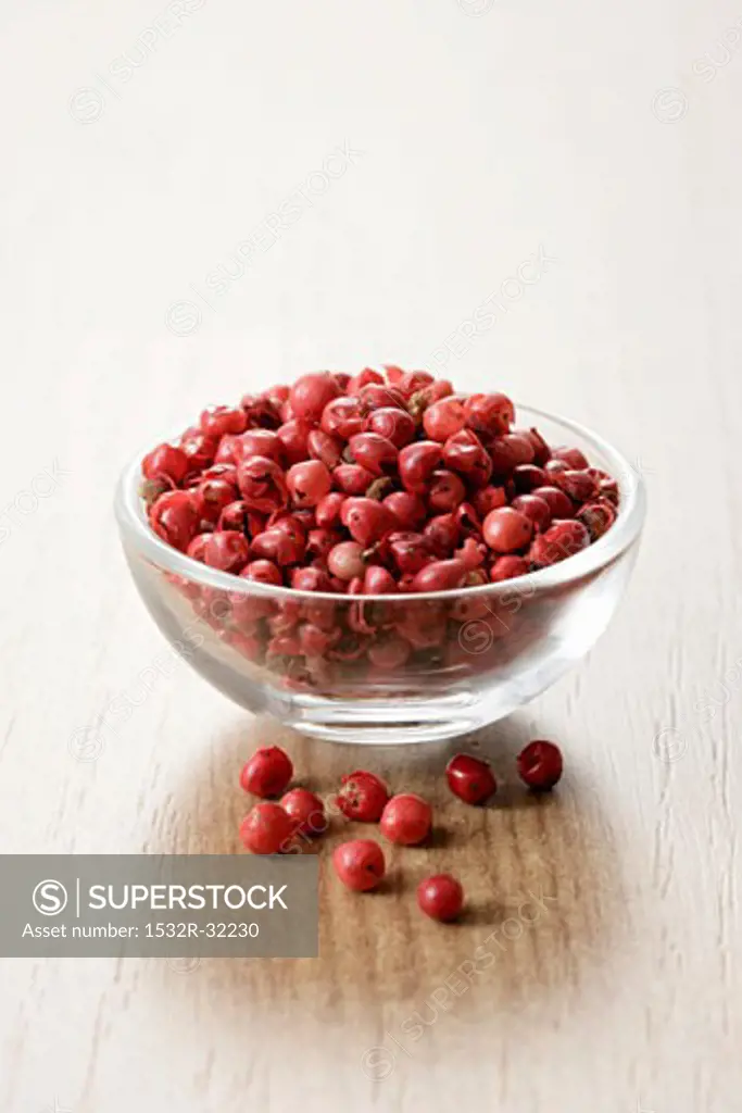 Red peppercorns in a small glass dish