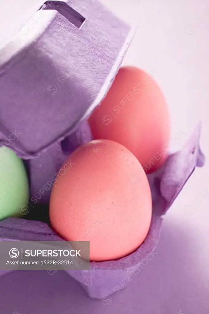Coloured eggs in egg box