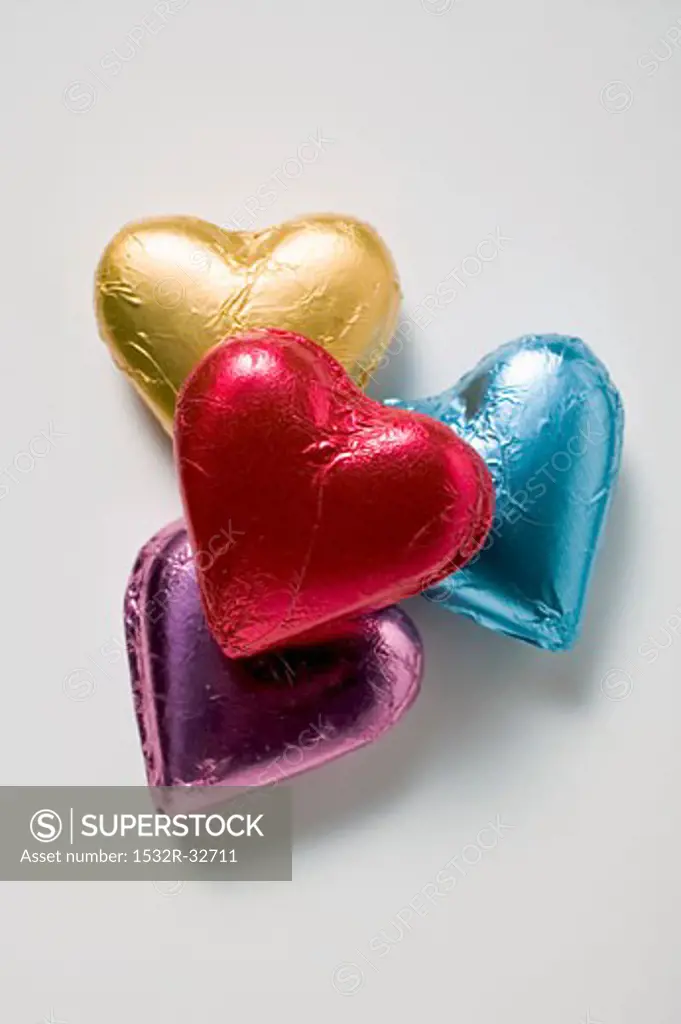 Four chocolate hearts in coloured foil