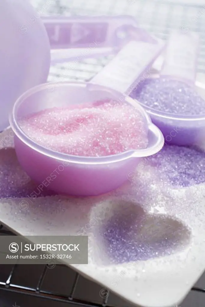 Coloured sugar for decorating biscuits on baking tin