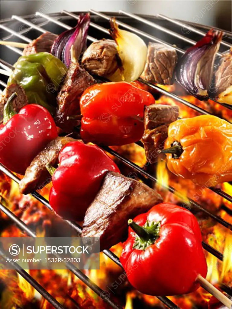 Meat and pepper kebabs on barbecue