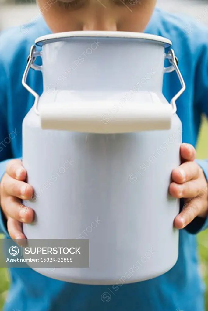Child drinking milk out of milk can