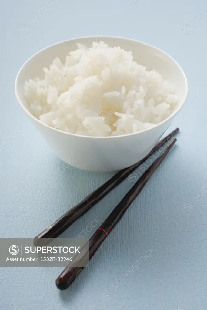 Bowl of rice, chopsticks beside it