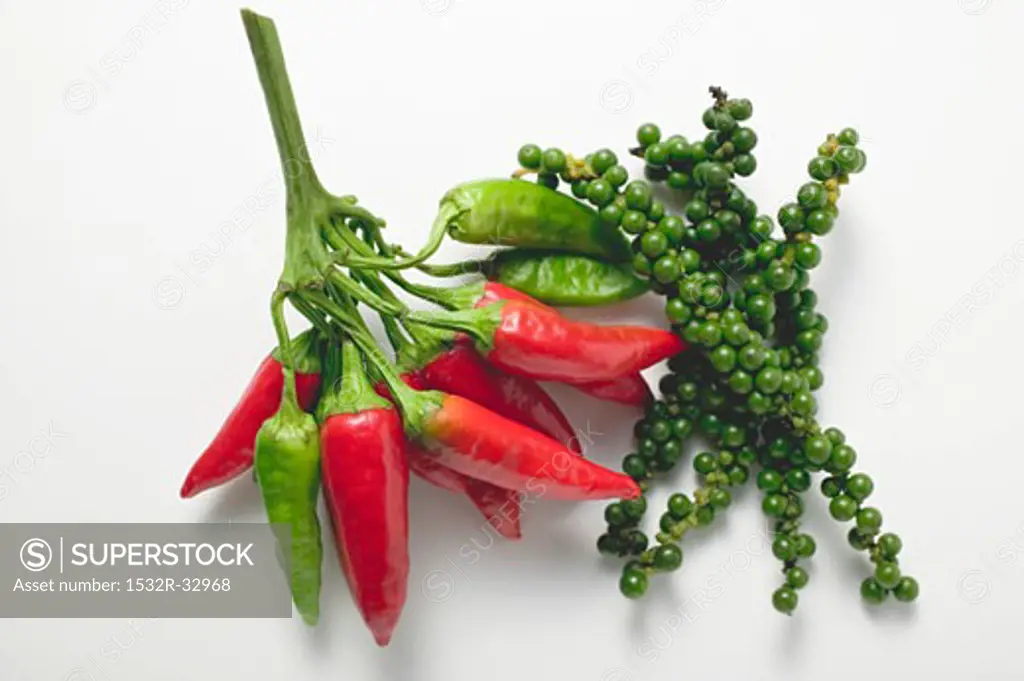 Chillies and clusters of green peppercorns