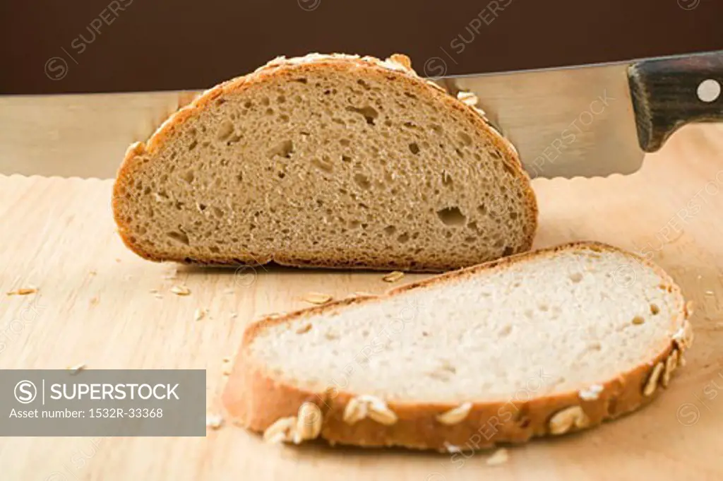Wholemeal bread with rolled oats, partly sliced