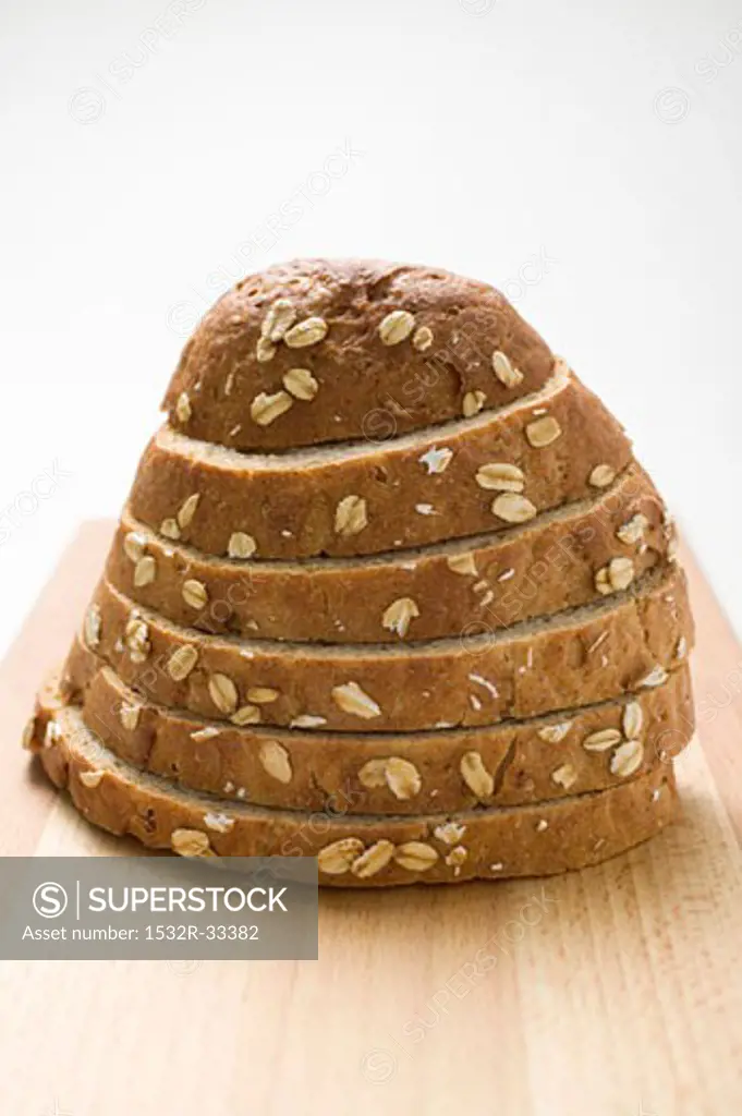Oat bread, sliced, on chopping board