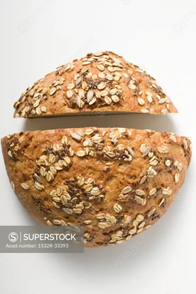 Wholemeal bread with pumpkin seeds, cut in two