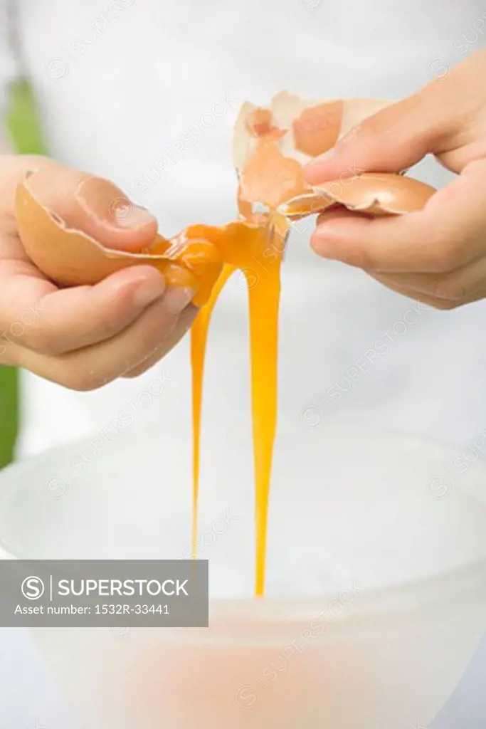 Child breaking an egg