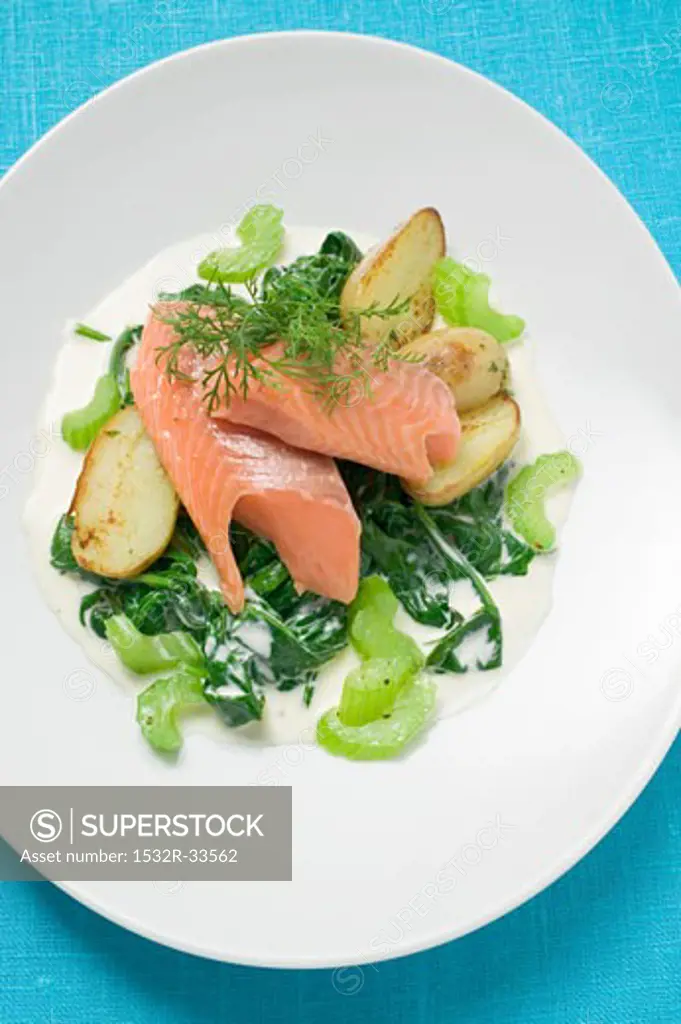 Salmon trout fillet with spinach, celery and potatoes