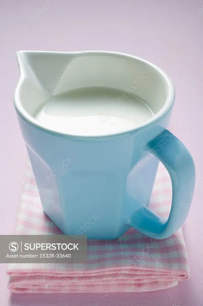 Milk in small jug on tea towel
