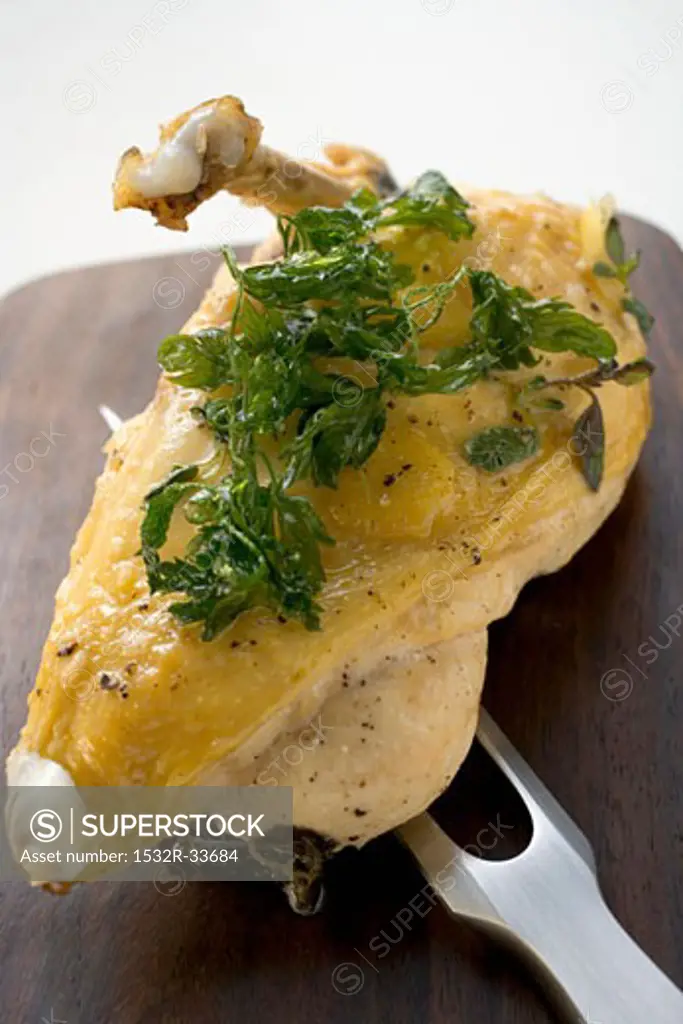 Chicken breast with deep-fried parsley on meat fork