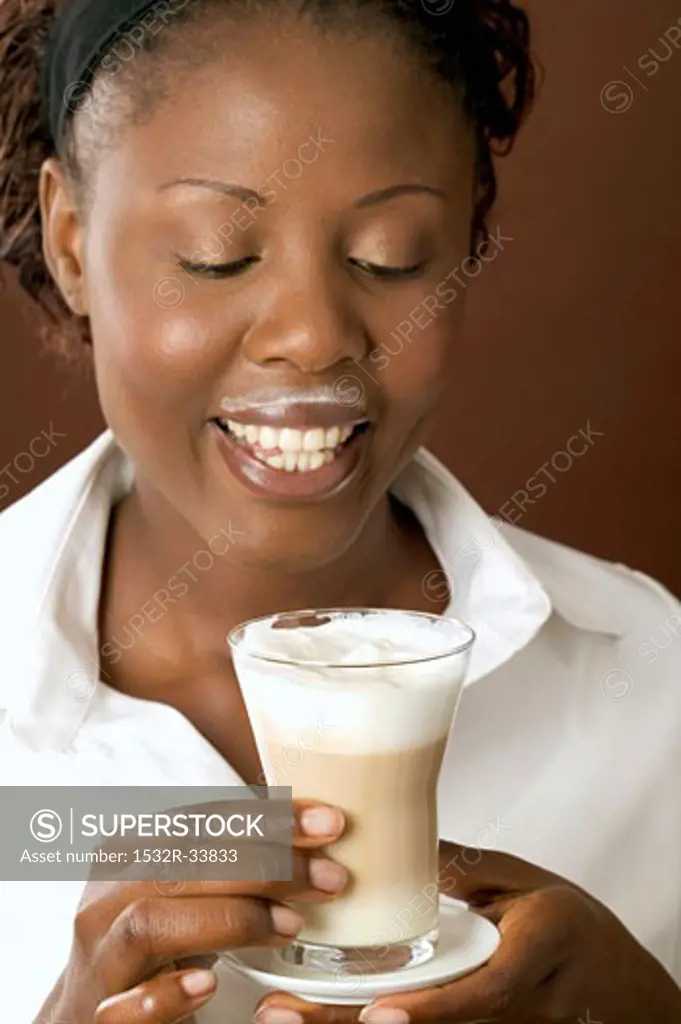 Woman drinking latte macchiato