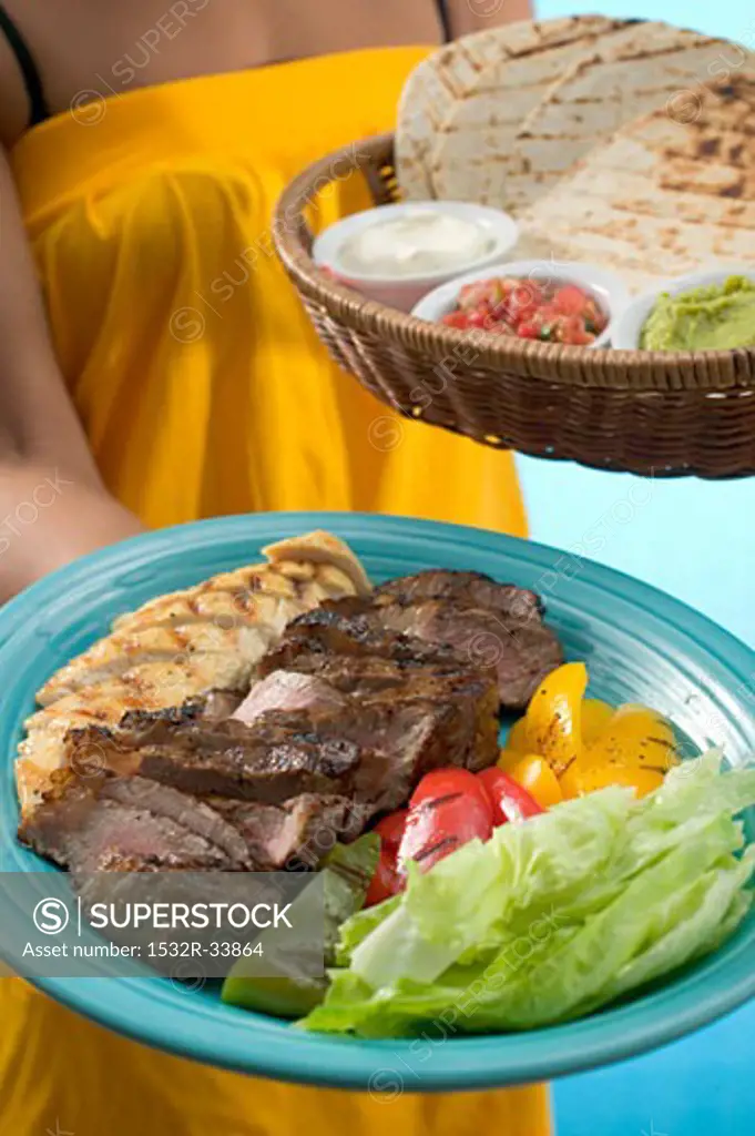 Woman serving Asian platter and basket of accompaniments