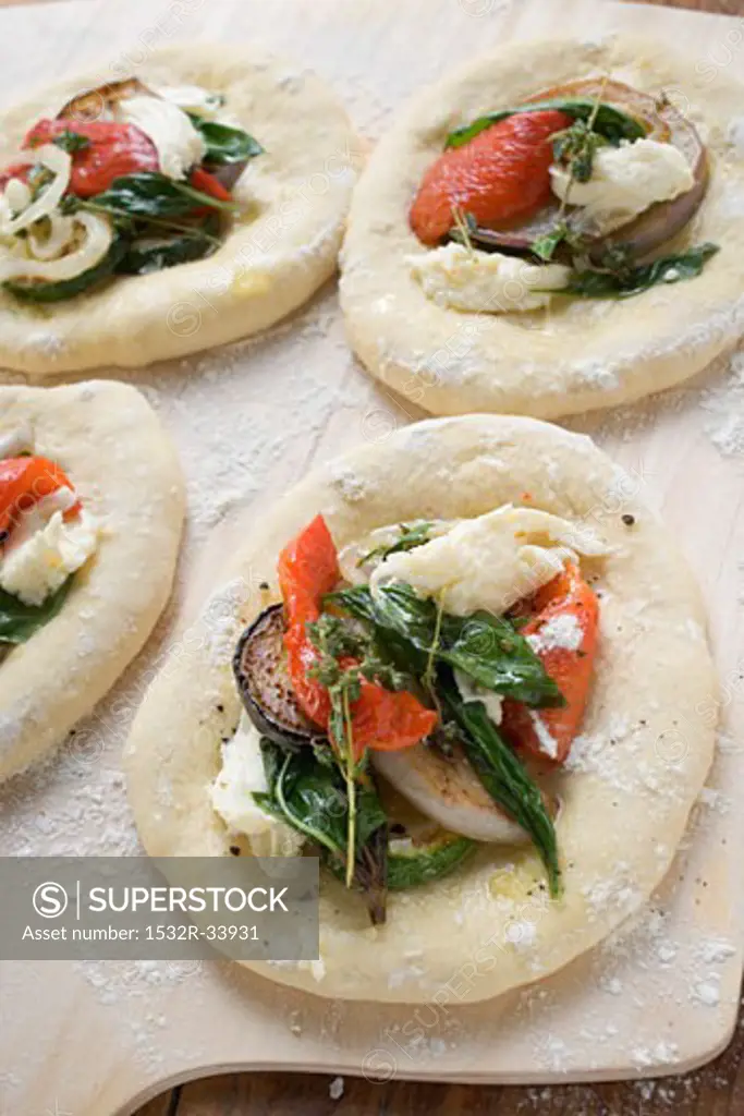 Focaccia topped with vegetables and basil
