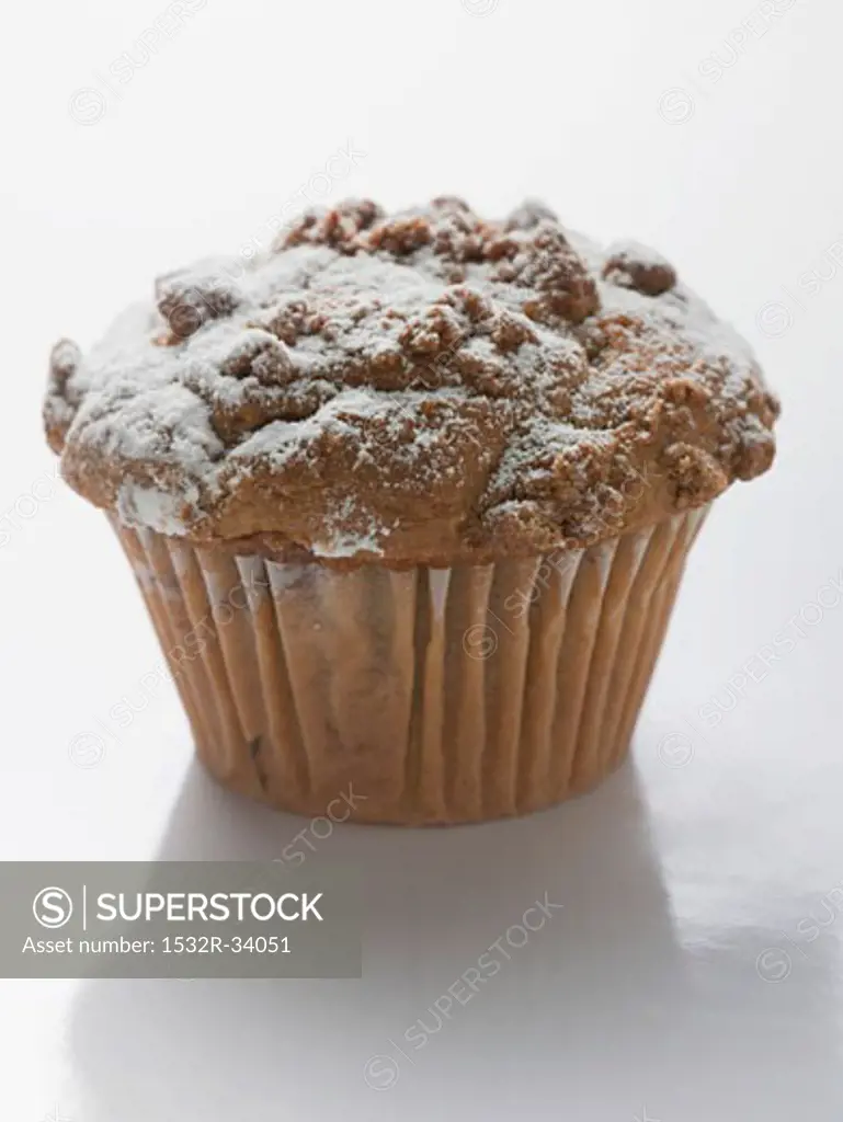Nut muffin sprinkled with icing sugar in paper case