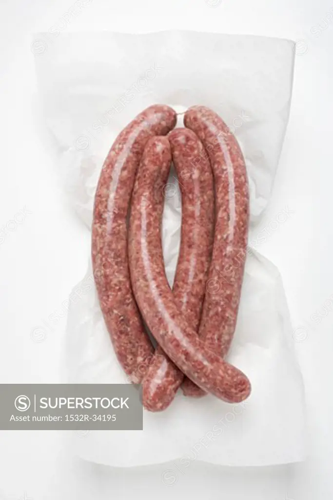 Four sausages on paper