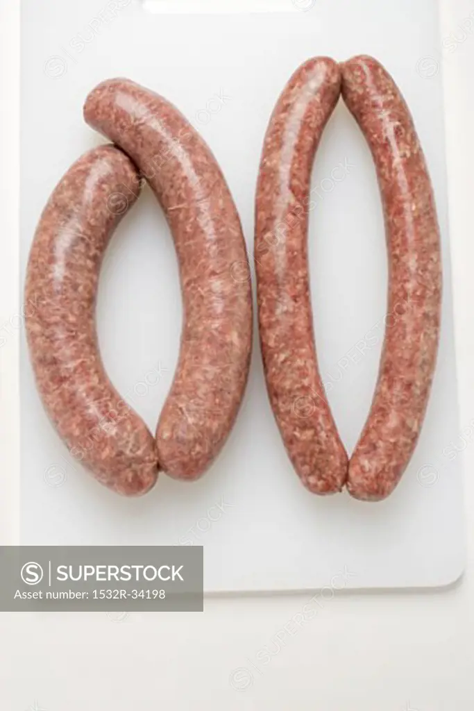 Two types of sausages on chopping board