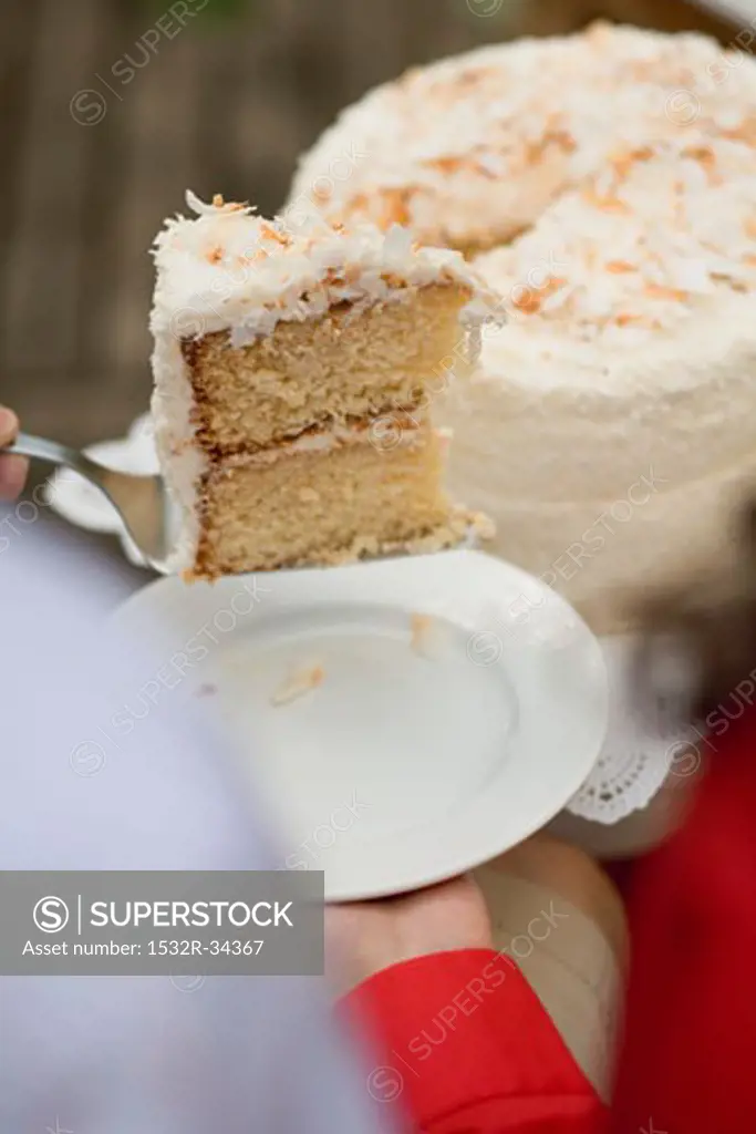 Man serving woman piece of coconut cake (4th of July, USA)